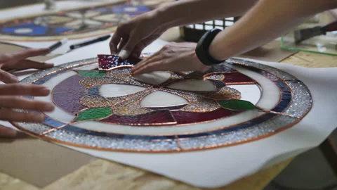 Two artists assemble a composition from stained glass windows. Assembling parts Stock-Footage 161408683