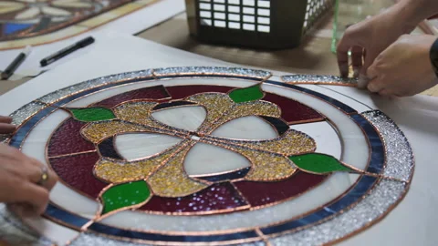 Two artists assemble a composition from stained-glass windows. Hands of two Stock Footage 161691573