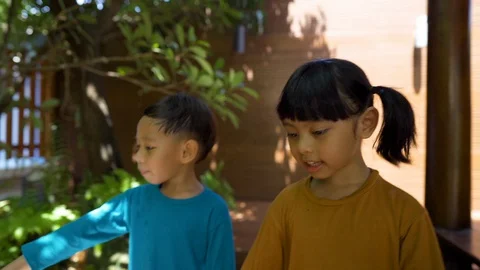 Two asian 3-4 years old kids quarantine stay home good time smiling Stock Footage 128942955