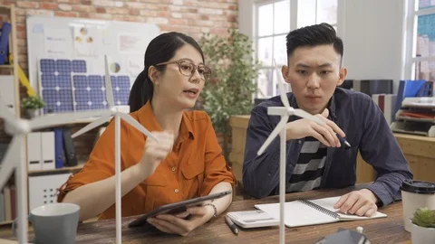 Two asian colleagues designing windmill Stock Footage 112116720
