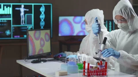 Two Asian Doctors In Protective Suit Are Doing A Science Experiments Stock Footage 157716936