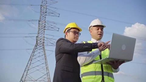Two asian electrical engineer working with laptop and look forward. Stock Footage 149804929