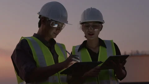 Two Asian engineer using a digital tablet at the petroleum Stock Footage 142976252