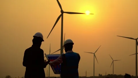 The two Asian engineers are checking the system for wind turbines Видео 105469129