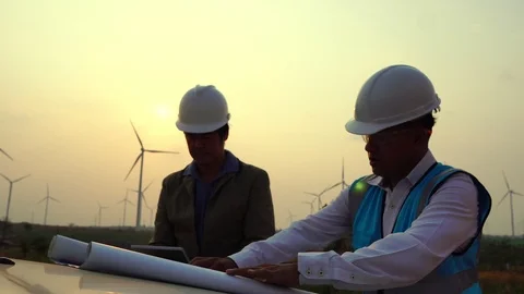 The two Asian engineers are checking the system for wind turbines Stock Footage 105472296