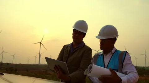 The two Asian engineers are checking the system for wind turbines Stockbeeldmateriaal 105475460