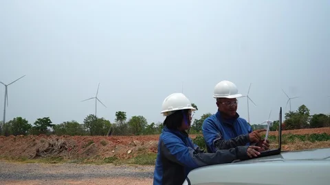 The two Asian engineers are checking the system for wind turbines footage 4K Видео 127913497