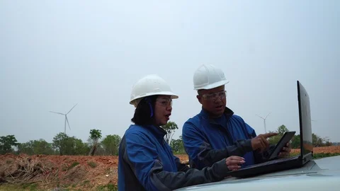 The two Asian engineers are checking the system for wind turbines footage 4K Stock Footage 127922293