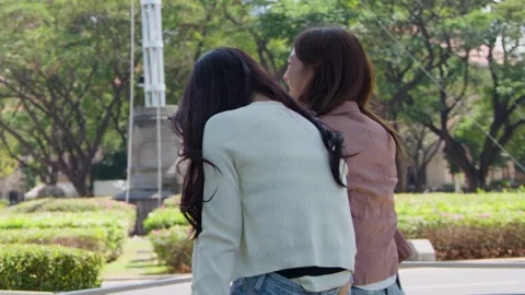 Two Asian Female Students Talking and Laughing on University Campus Garden Stock Footage 341322782