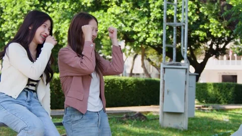 Two Asian Female Students Talking and Laughing on University Campus Stock Footage 341322814