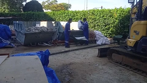 Two Asian Male Workers Dumping Construction Waste into Trash in Outdoors Stock Footage 309306752