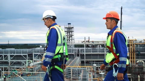 Two Asian man metalworker builder walking at refinery construction industrial Stock Footage 254693310