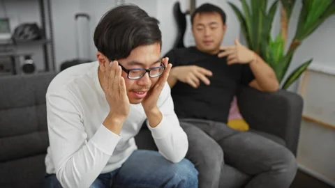 Two asian men emoting stress and comfort... | Stock Video | Pond5