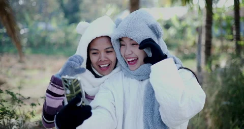Two Asian siblings are taking a selfie together with mobile phone. Stock-Footage 300825769