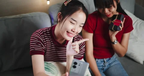 Two Asian siblings pose for a selfie happily and joyfully  Видео 305146743