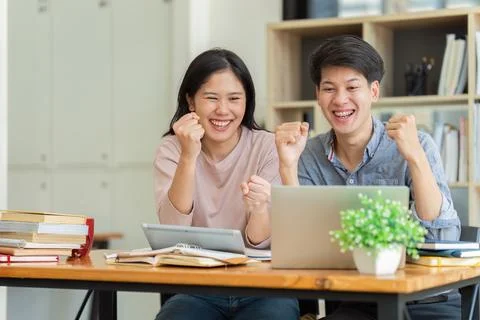 Two Asian students learning together and tutor together at cafe and a celebrate Stock Photos