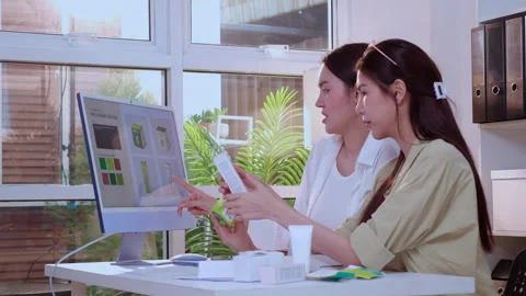 Two asian woman designer using AI artificial intelligence assistant for cos.. Stock Footage 330333778