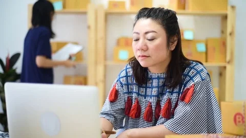Two Asian Womans Working at home, Young business start up Stockbeeldmateriaal 83049732
