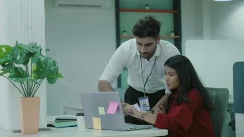 Two Asian workers talking in office young Indian colleagues discussing work. Видео 163403359