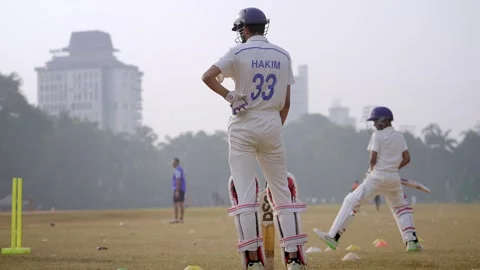 Two aspiring young cricket players improving batting stance in training academy 動画素材 326409875