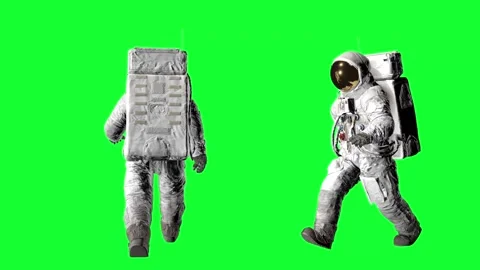 Two astronauts in full spacesuits with life support backpacks walking against Stock Footage 316772946