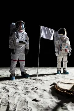 Two astronauts on the moon, a blank white flag in between them Stock Photos