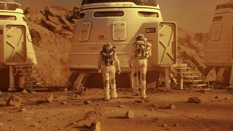 Two astronauts in spacesuits walk toward base on Mars Stock Footage 247089379