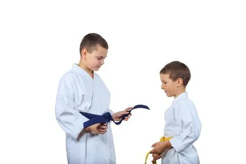 Two athletes with different colored belts on a white isolated background Stock Photos