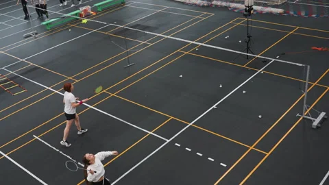 Two athletes engage in competitive badminton training session. Energetic players Stock Footage 345551824