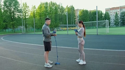 Two athletes focus on box training at sports field wrapping hands. Training Video stock 316472597