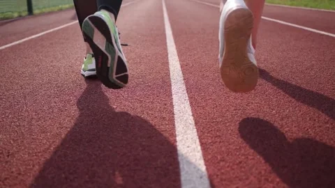 Two athletes jogging on outdoor running track view. Stock Footage 335713068