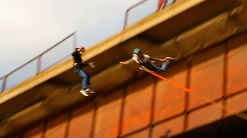 Two athletes jump from the bridge "jack" Stock Footage 34363531
