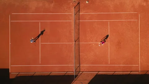 Two Athletes Practicing Tennis on Clay Court 库存影片 317953453