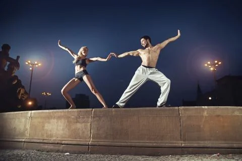 Two athletes practising in the night Stock Photos