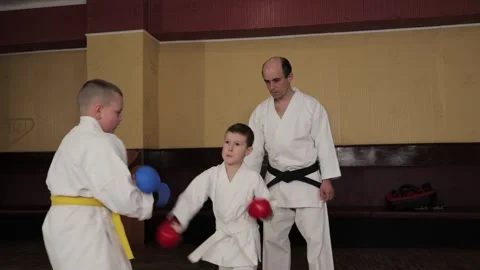 Two athletes with red and blue pads on their hands train punches and blocks Stock Footage 317690956