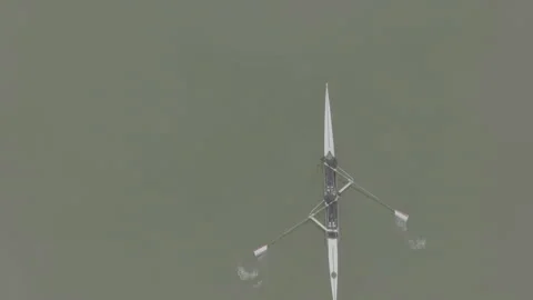 Two athletes rowing a sculling boat on calm water, teamwork and endurance in Stock Footage 319528871