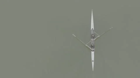 Two athletes rowing a sculling boat on calm water, teamwork and endurance in Stock Footage 319529908