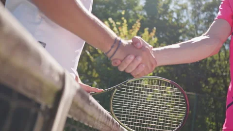 Two Athletes Shake Hands over Tennis Net 動画素材 317959091