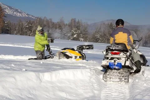 Two athletes snowmobile Stock Photos