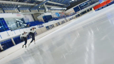 Two Athletes in Speed Skating Uniforms Sprinting Stock Footage 252248224