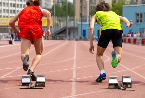 Two athletes start running 100-meter Stock Photos