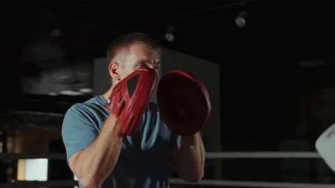 Two athletes training on special kickboxing gloves. Stock Footage 253979384