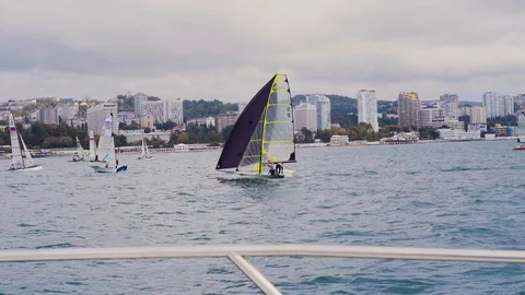 Two athletes very quickly pull the ropes of the sail to deploy the boat. Stock Footage 107031372