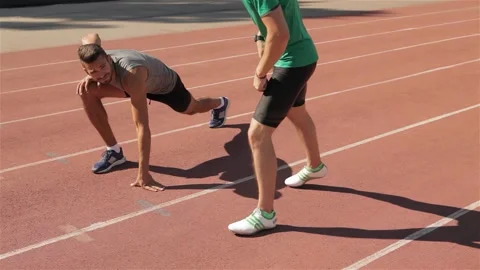 Two athletes warm up at the stadium Stock Footage 311673422