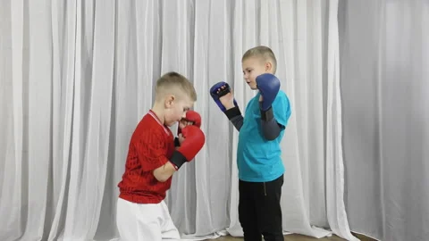 Two athletes wearing multi-colored T-shirts perform pair exercises Stock Footage 150127941