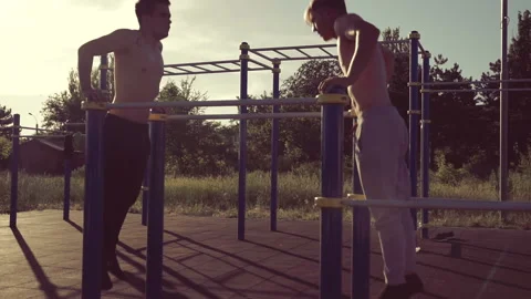 Two athletic mens training on parallel crossbars Video stock 91164093