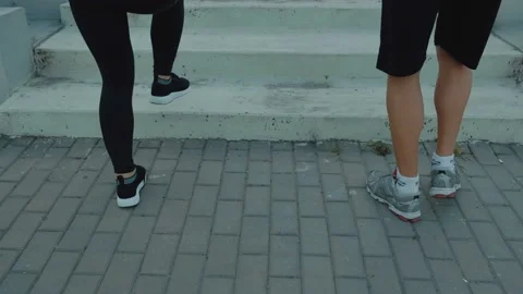 Two athletic runners legs running up stairs training intense cardio exercise Stock Footage 115964188