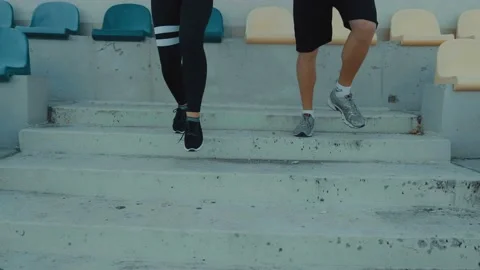 Two athletic runners legs running up stairs training intense cardio exercise Stock Footage 115964193