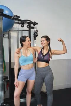Two athletic women smiling while posing together in the gym. Foto stock