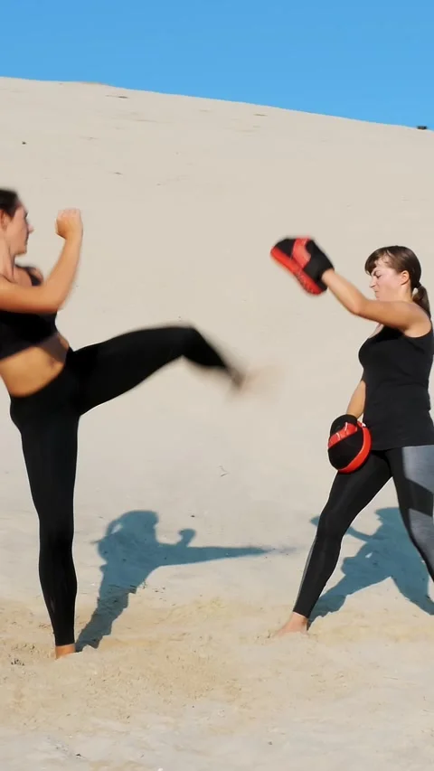 Two athletic, young women in black fitness suits are engaged in a pair, work out Stock Footage 313343460